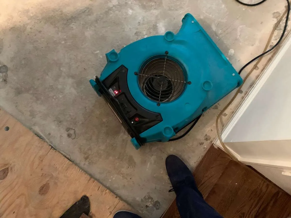 Air mover drying subfloor during Commercial Water Damage Restoration in Solana Beach